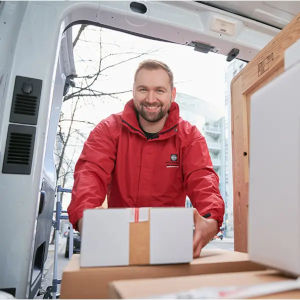 Mann Packt Paket in Transporter